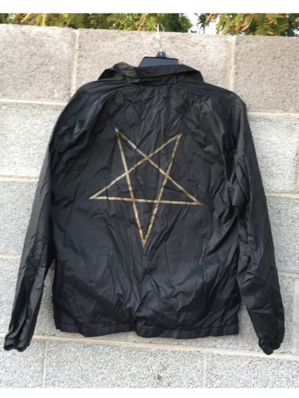 Trasher pentagram windbreaker in black and gold